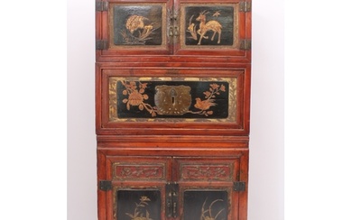 A Chinese red stained pine, lacquered and parcel-gilt three-...