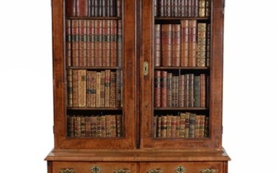 A GEORGE II WALNUT CABINET OR BOOKCASE ON CHEST, CIRCA 1730