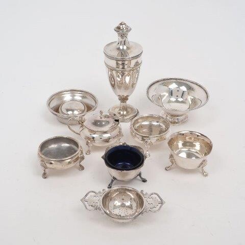 A George V silver caster, Sheffield, 1913, William Hutton & Sons, the urn-shaped body raised on a circular foot, 16.5cm high, together with: two George III silver salt cellars, London, 1767 & 1770, William Kersill, each raised on three pad feet; a...