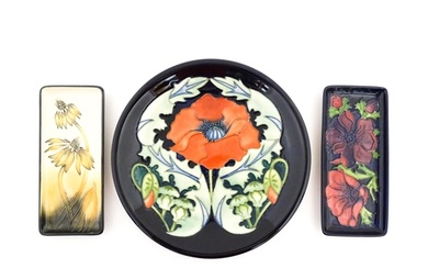 A Moorcroft plate decorated in the Poppy plate designed by R...