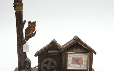A NOVELTY MUSICAL COMBINATION ALARM CLOCK AND LAMP IN THE FORM A WATERWHEEL AND CABIN, 28 CM WIDE, 27 CM HIGH, 11 CM DEEP