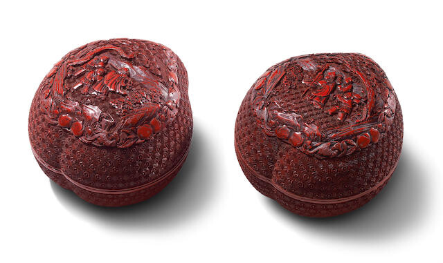 A PAIR OF CINNABAR LACQUER CARVED PEACH-SHAPED 'DAOIST IMMORTALS' BOXES AND COVERS