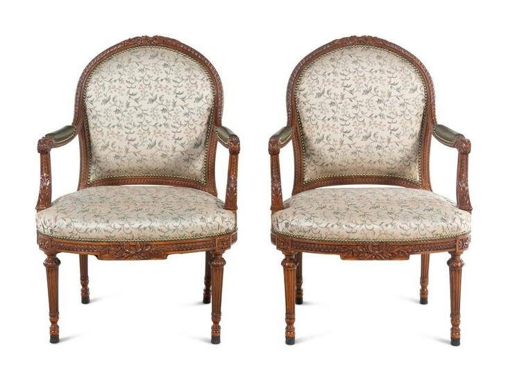 A Pair of Louis XVI Carved Walnut Fauteuils
