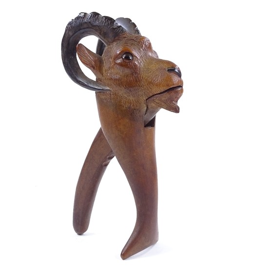 A Tyrolean carved wood ibex design nutcracker with glass eye...
