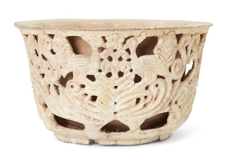 A carved pottery bowl, Southeast Asia,19th century or earlier, of deep form with double skin, the outer openwork shell carved with birds and vegetal designs, the inner skin solid, 29cm. diam. x 16cm. high Provenance: Private Collection Oliver Hoare...