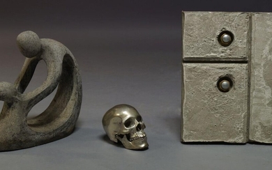 A cast white metal skull, 20th Century, together with a...