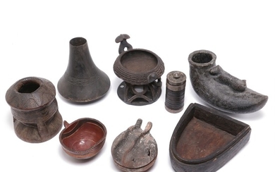 A collection of containers and jugs of fired clay and carved patinated wood. Central- and Western Africa. H. 9–24 cm. (8)
