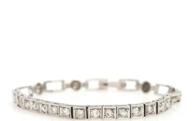 A diamond bracelet set with numerous old mine-cut diamonds weighing a total...