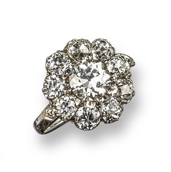 A diamond cluster ring, set with old circular-cut...