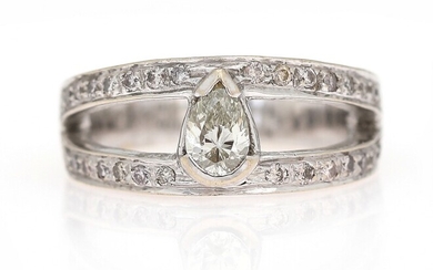 SOLD. A diamond ring set with a pear-shaped brilliant-cut diamond flanked by numerous diamonds, mounted...
