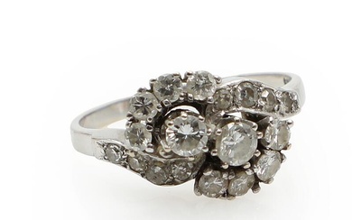 A diamond ring set with numerous brilliant- and single-cut diamonds weighing a...