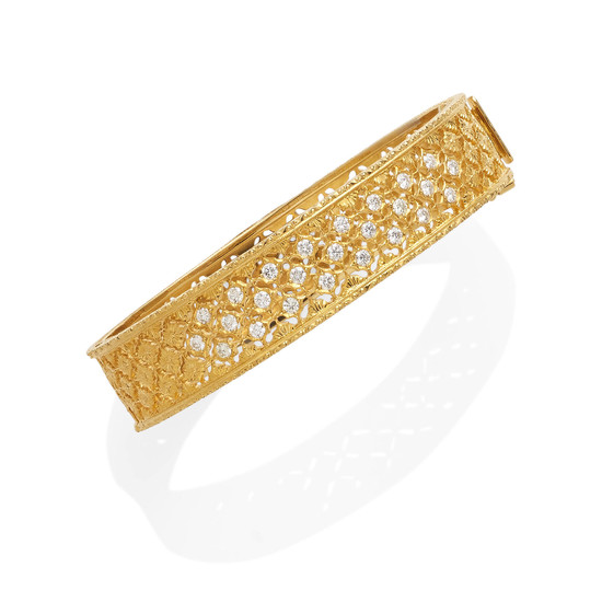 A gold and diamond hinged bangle bracelet