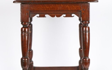 A good Charles I oak joint stool, circa 1630, having a top with ovolo moulded edge, bicuspid