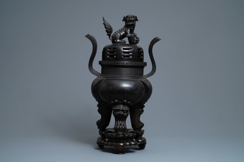 A large Chinese bronze incense burner and cover...