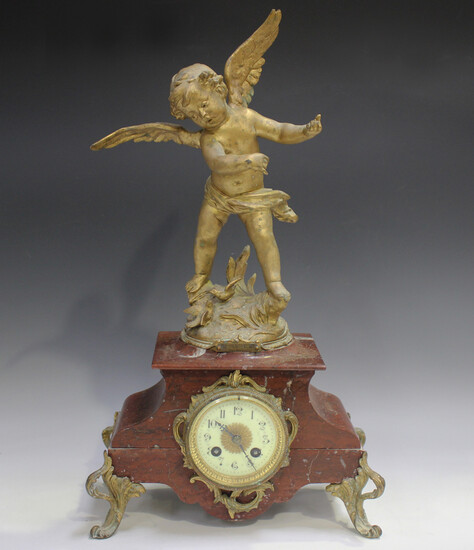 A late 19th/early 20th century French gilt metal and rouge marble mantel clock with eight day moveme
