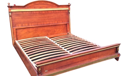A mahogany Empire style bed, the headboard with arched cornice...