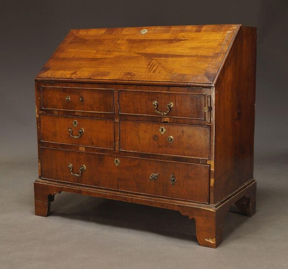 A mahogany bureau, late 19th, early 20th Century, the fall enclosing burgundy baize lined writing surface and drawers, over four short and one long drawer, raised on bracket feet, 105cm high, 82cm wide and 52cm deep