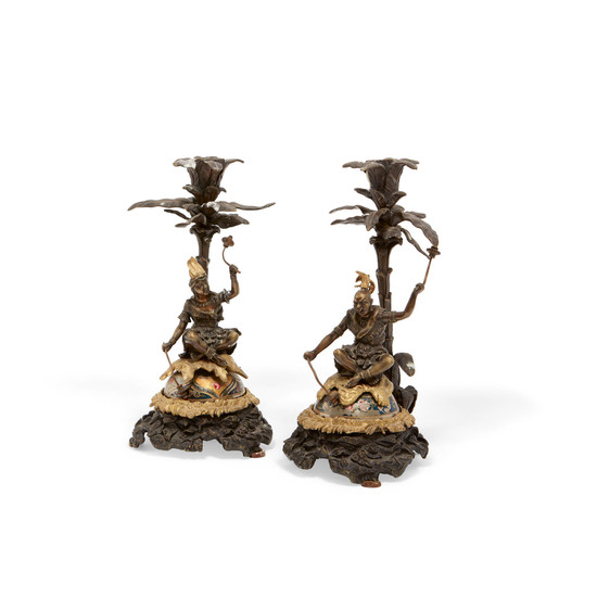 A pair of Continental parcel gilt bronze articulated figural candlesticks