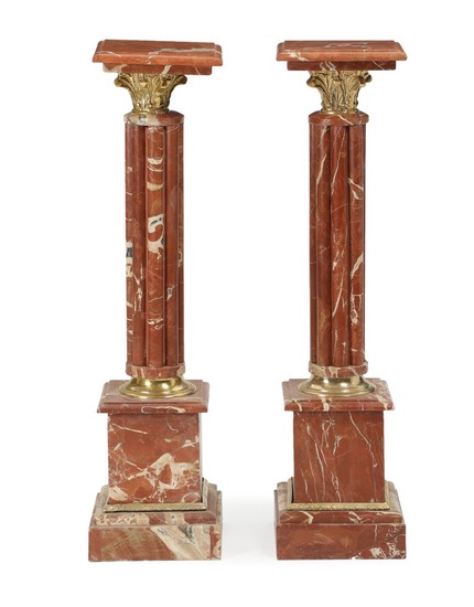 A pair of Louis XVI style reddish marble and bronze pedestals. 20th-21st century. H. 102. W. 26. D. 27 cm. (2)