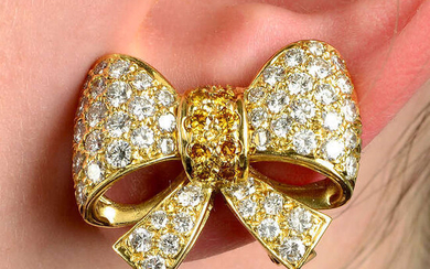 A pair of pavé-set 'yellow' diamond and diamond bow earrings.
