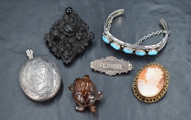 A small selection of vintage jewellery including black mourning brooch, silver locket having