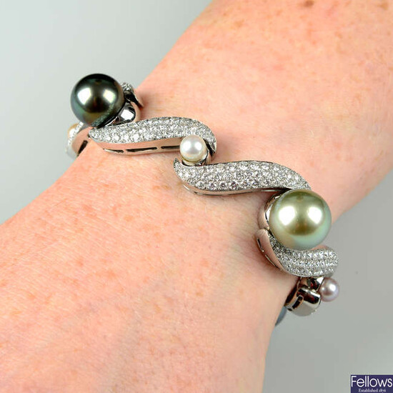 A vari-hue 'South Sea' cultured pearl and pavé-set diamond scroll bracelet, with vari-hue cultured pearl spacers.