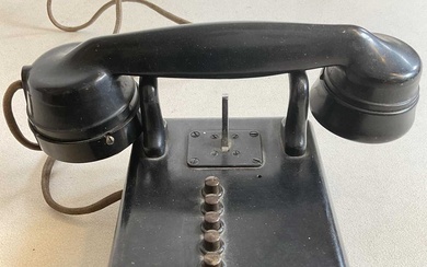 A vintage black bodied wall mounted telephone with five buttons...