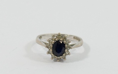 A white gold oval sapphire and diamond cluster ring, London ...