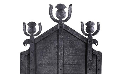 AN ARTS AND CRAFTS WROUGHT IRON FIREGRATE PROBABLY RETAILED BY LIBERTY & CO.