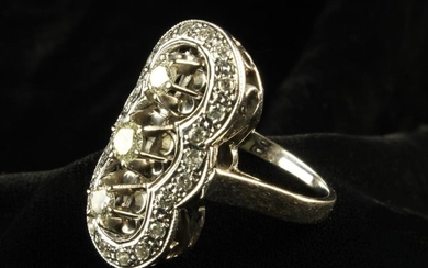 An Art Deco Style White Gold & Diamond Ring with three princess cut stones framed by an oval serpent