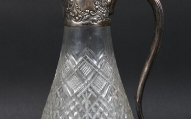 An Edwardian silver mounted cut glass claret jug