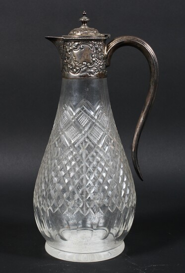 An Edwardian silver mounted cut glass claret jug