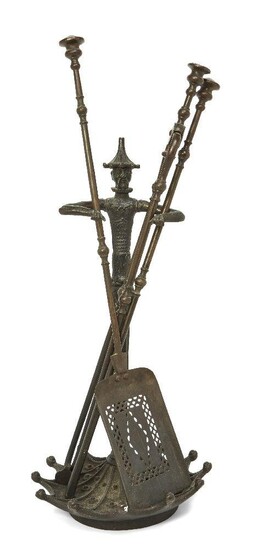 An English cast-iron fire-tool stand, early 20th century, modelled as Chinese figure with out-stretched arms, the base as an inverted umbrella, 59cm high; together a set of three steel fire-tools, early 19th century, the shovel - 73cm long (4)