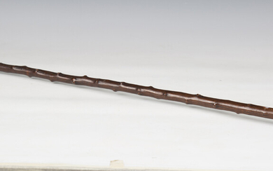 An early 20th century walking cane, the cast metal handle modelled in the form of a skull, length 87