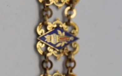 BROCHE en pendentif en or, attache à motif d'une fleur de lys Chainette stylisée tenant...