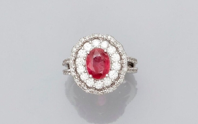 Beautiful ring in white gold, 750 MM, centered of an oval ruby weighing 2.10 carats in a cushion of brilliant-cut diamonds between two diamond palms, total about 1.80 carat, 17 x 15 mm, size: 54, weight: 9.95gr. rough.