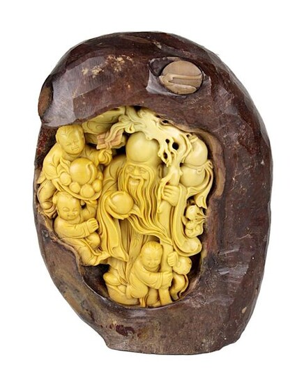 Chinese soapstone carving, around 1920, carved from one piece of two-coloured soapstone, Shou Xing, the god of longevity, surrounded by children and fruit, height 18.5 cm, width 14 cm, weight 2615 g. 2541-032