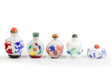 Five Chinese overlay snuff bottles 20th century Comprising: a blue overlay on...