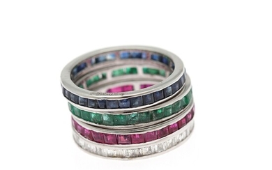 Four rings respectively set with diamonds, sapphires, emeralds and rubies, mounted in 14k white gold. Size 52.5. (4)