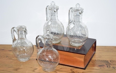 Four small engraved crystal decanters (one incomplete stopper)...