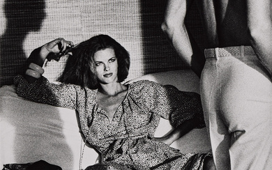 HELMUT NEWTON (1920-2004) Woman examining man, from American Vogue, St. Tropez.