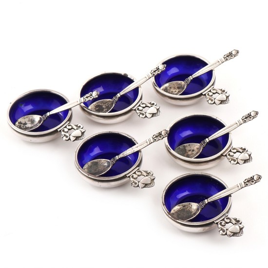 Johan Rohde: “Acorn”. A set of six sterling silver salt cellars, interior decorated with blue enamel, with belonging spoons. Georg Jensen, after 1945. (12)