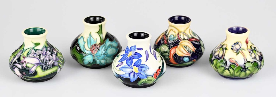 MOORCROFT; five miniature baluster shaped vases, each with floral decoration,...