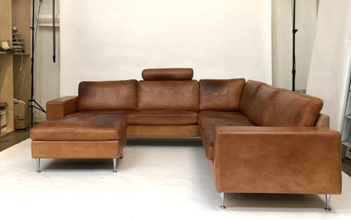 Mogens Hansen: A corner couch and stool with patinated cognac coloured leather, brushed steel legs. Model 221. L. 270. W. 270 cm.