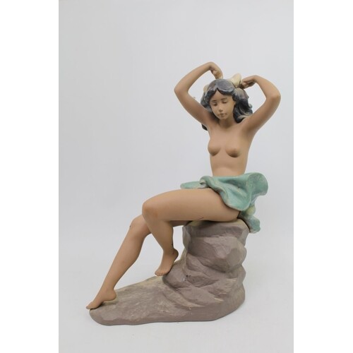 Nao Gres figure of a semi nude on rocky outcrop. 38cm in Hei...