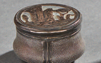 Small circular silver box in shagreen; the lid...