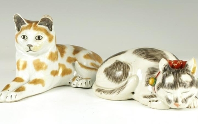 TWO CONTINENTAL PORCELAIN RECUMBENT CATS with coloured
