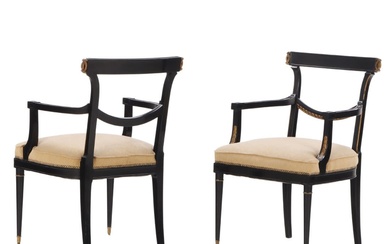 UNUSUAL PAIR OF EBONIZED AND GILT CARVED OPEN ARM CHAIRS...