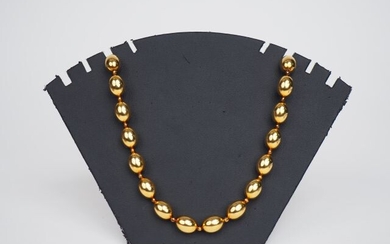 Yellow gold pearl necklace.