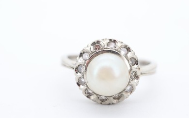 19.2K gold ring with diamonds and pearl. <br> <br>Set with:...